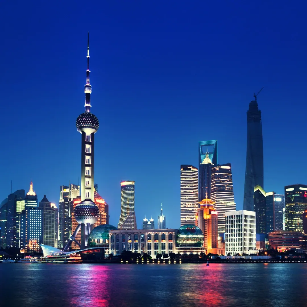 Vista panorámica de Shanghái, China, con sus modernos rascacielos y edificios iluminados junto al río Huangpu.